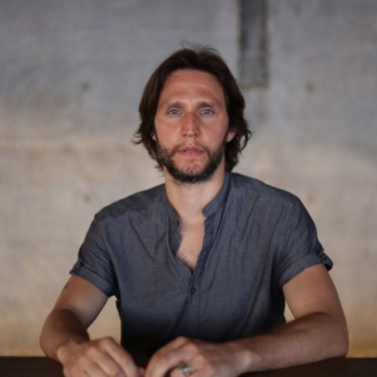 Tony Orrico sits at a table