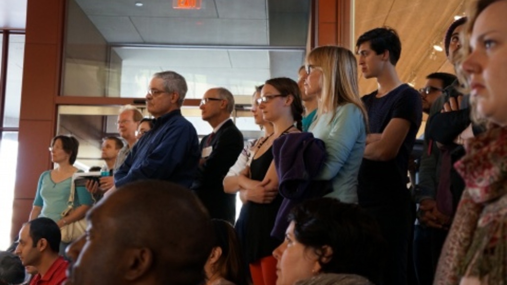 People standing in classroom during Grant Wood Art Colony symposium lecture.