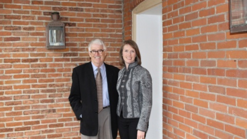 Jim Hayes, owner of 1142 East Court Street, and Maura Pilcher, Director of the Grant Wood Art Colony stand on the porch of 1142, formerally owned by Grant Wood himself.