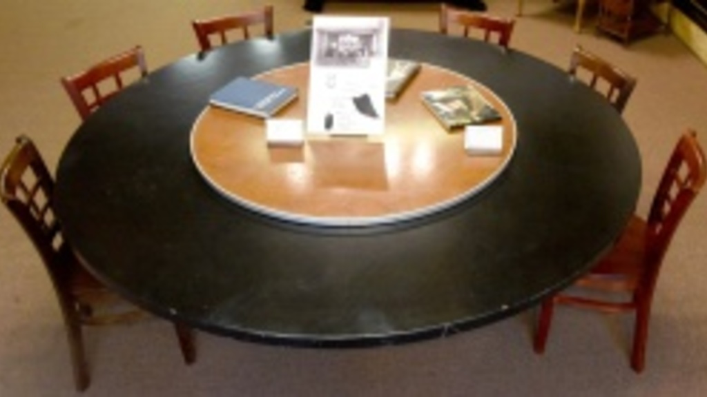large, black, round table with 6 chairs