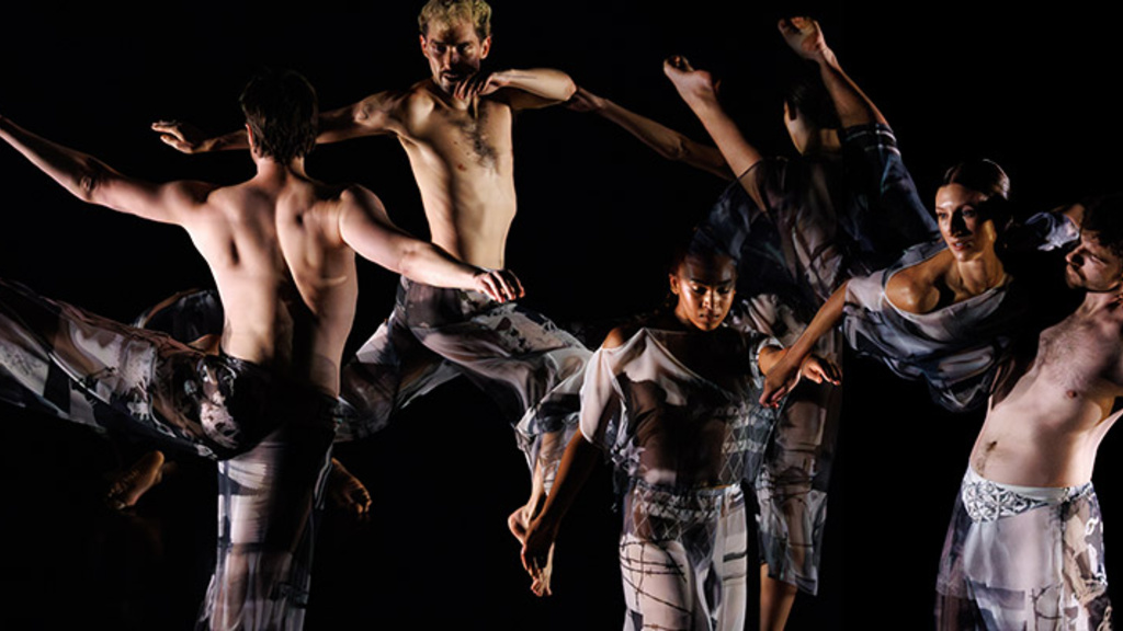 Six people in various positions wearing grey and black clothing